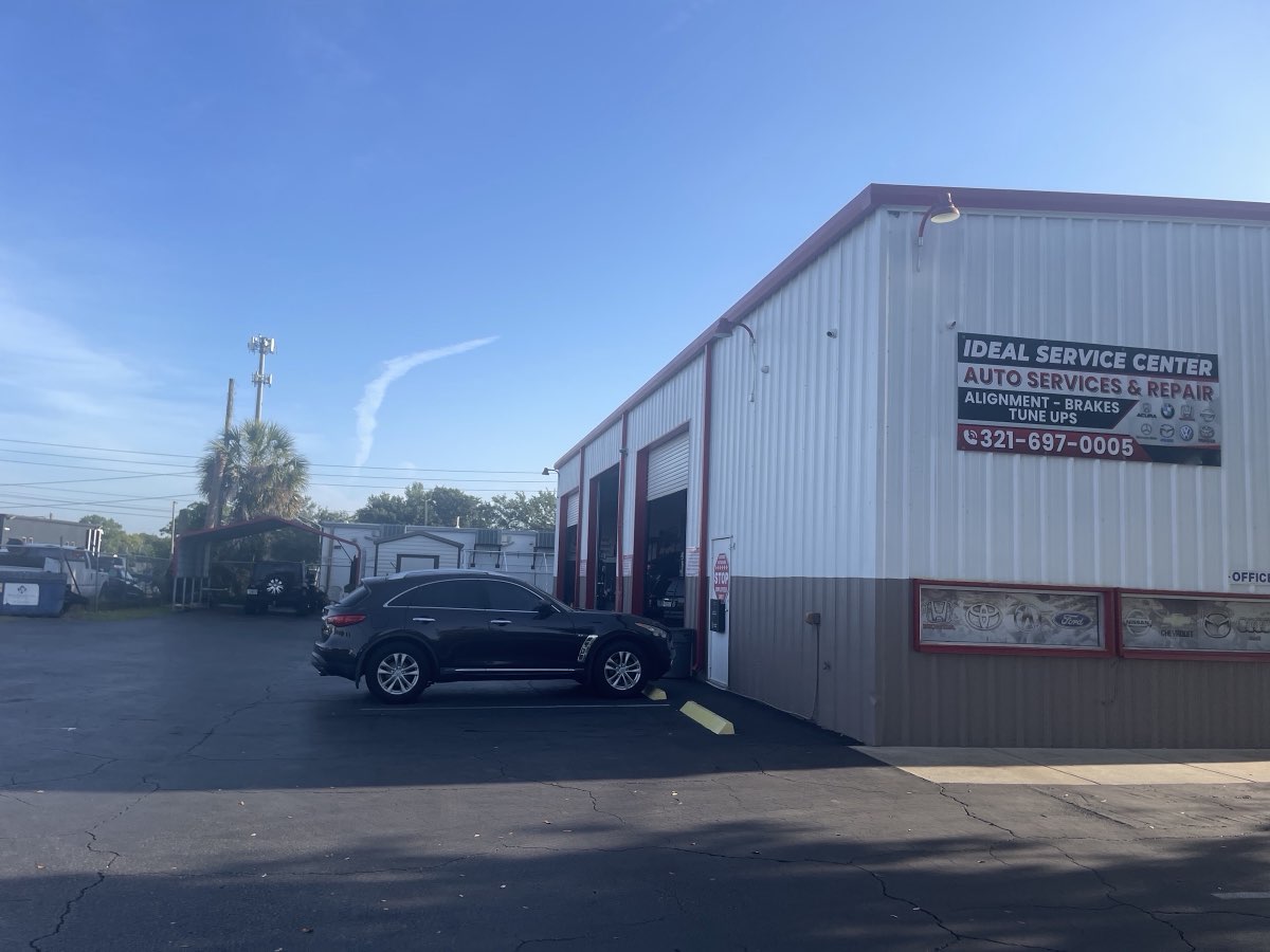 Ideal Service Center on West Keen Street, Kissimmee - white steel shop building with open service bays